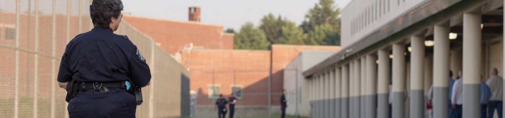 Woman guard walking in prison yard